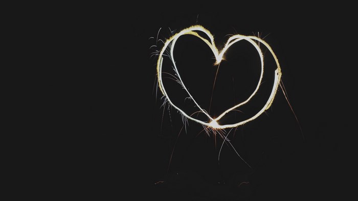Heart shape light trail on black background