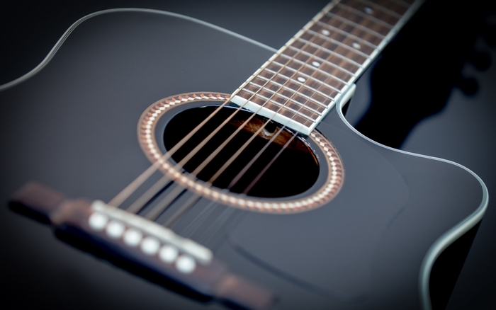 Close-up of a black acoustic guitar