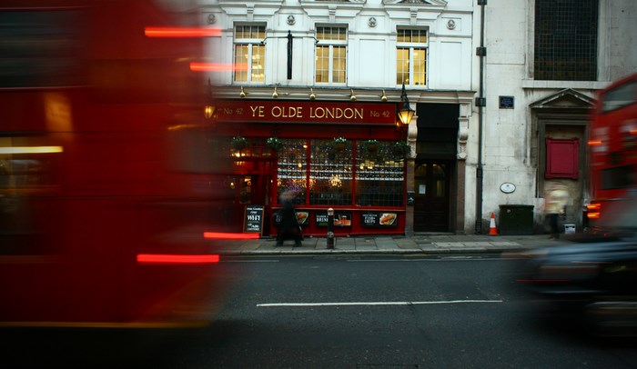 Motion blur of red bus and Ye Olde London pub