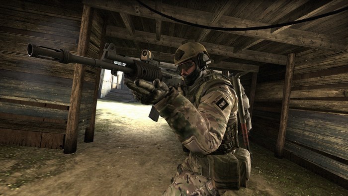 Soldier aiming rifle in wooden structure