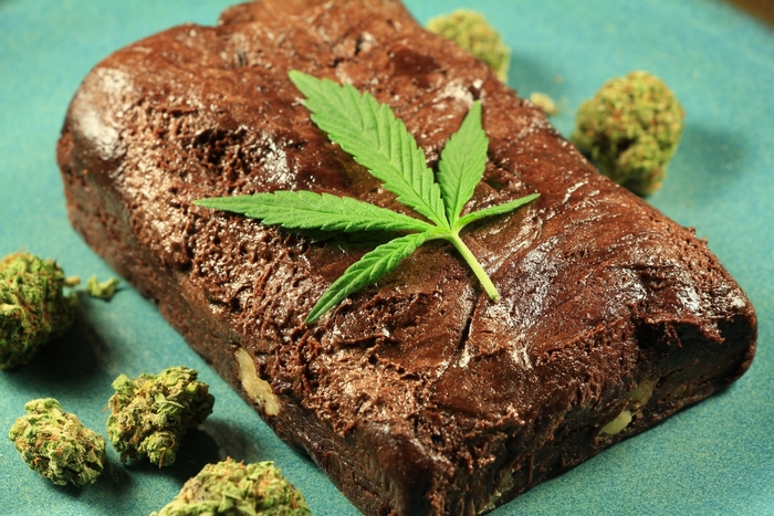 Chocolate brownie with marijuana leaf and buds