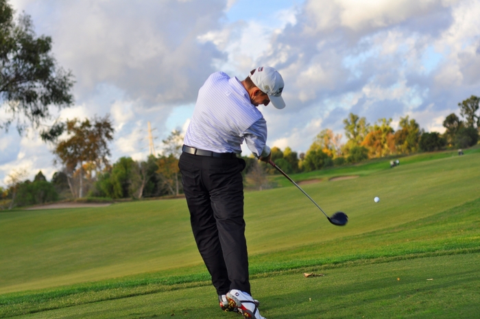 Golfer hitting a drive on a golf course
