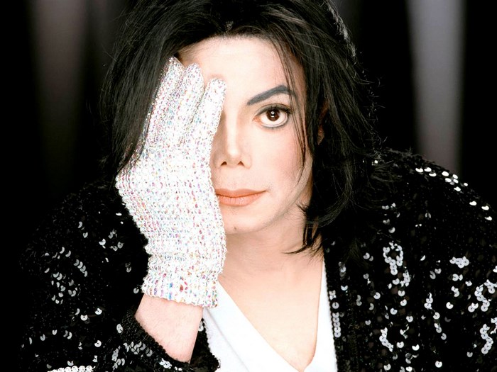 Michael Jackson wearing a sequined jacket and glove