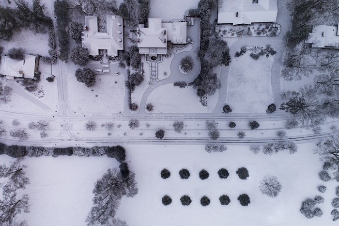 Aerial view of a snowy neighborhood with houses and trees