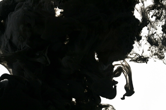 Black ink dissolving in water
