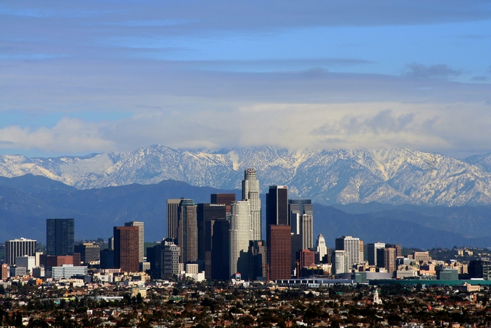 Los Angeles skyline with snow-capped mountains