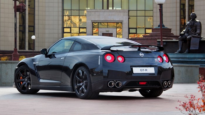 Black Nissan GT-R parked near a building