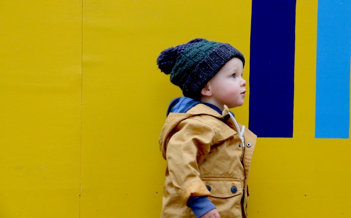 Child in a knitted hat and jacket
