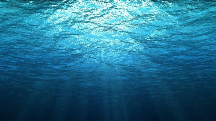 Underwater scene with sun rays penetrating the water