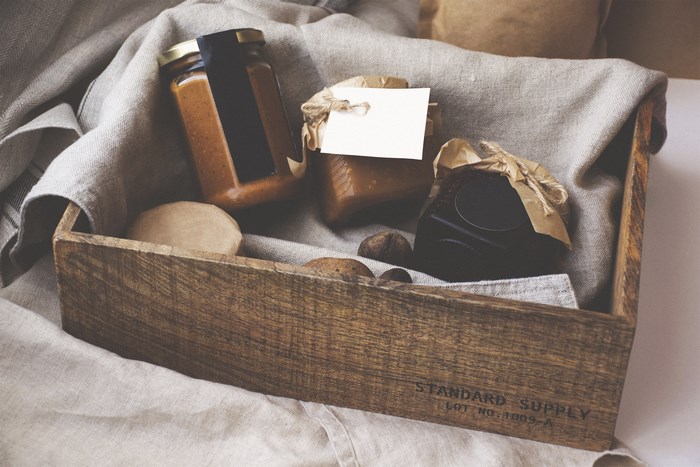 Wooden box with jars of preserves and food