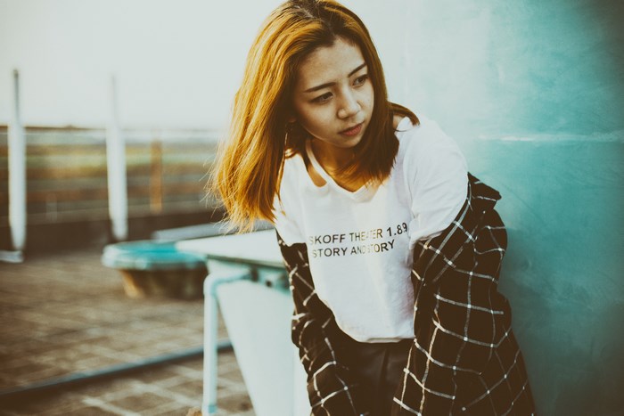 Portrait of Asian Redhead Woman in Urban Sunlight