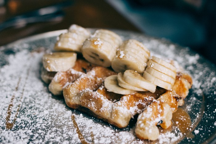 Waffle with sliced bananas and powdered sugar