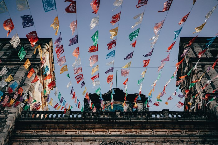 Colorful Papel Picado Flags Over Mexican Architecture