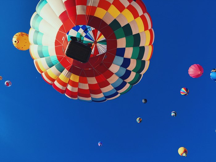 Colorful hot air balloons against a blue sky