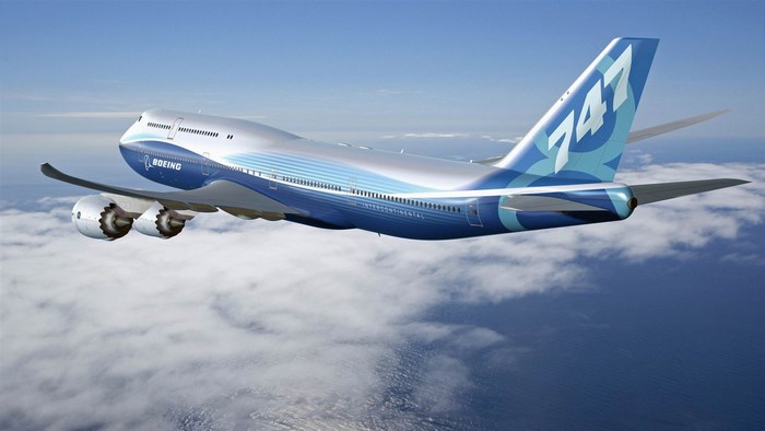 Boeing 747 airplane flying over clouds
