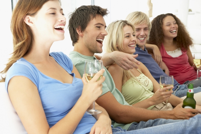 Group of friends laughing and drinking