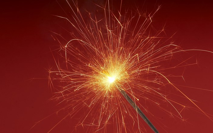 Sparklers on red background