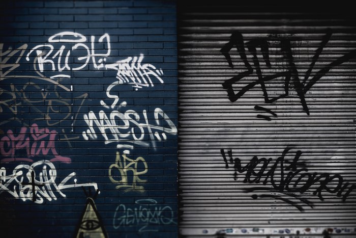 Urban Blue Brick Wall with Graffiti on Metal Shutter
