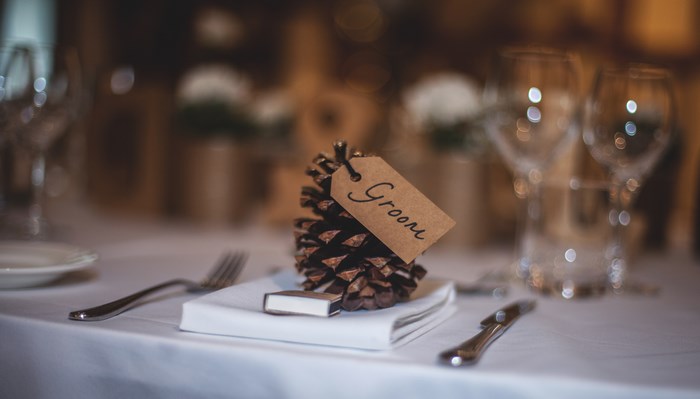 Pinecone place setting for the groom at a wedding reception