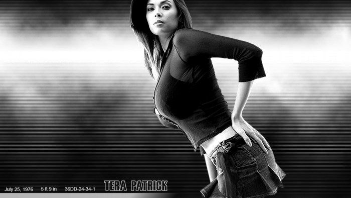 Tera Patrick posing in a black top and denim skirt