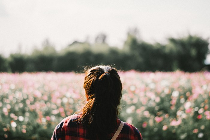 Woman in Plaid Shirt in Flower Field