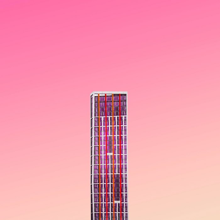 Modern skyscraper with colorful facade against pink sky