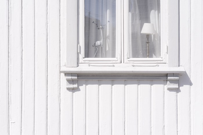 White wooden house with a window and decorations