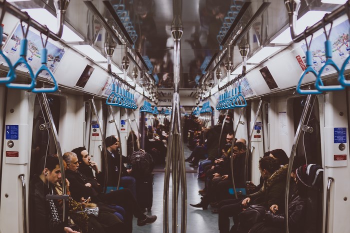 Commuters on a busy subway train