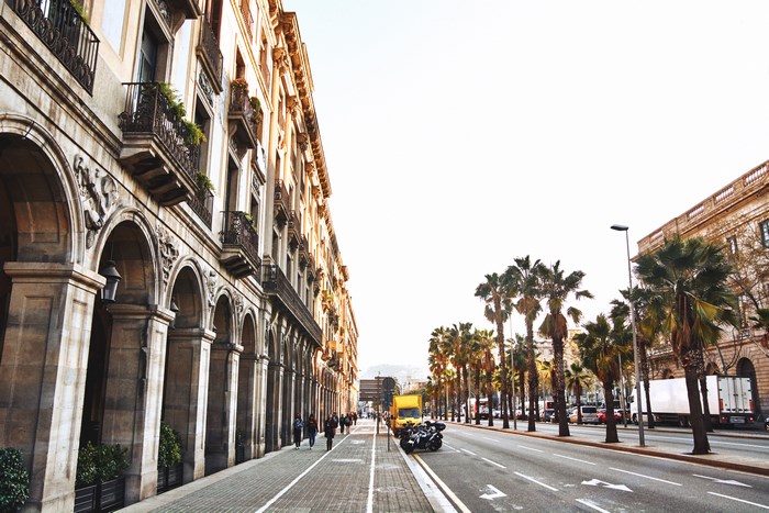 Street with Arches, Balconies, and Palm Trees