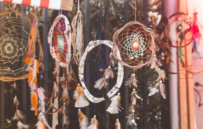 Dream catchers with feathers hanging outdoors