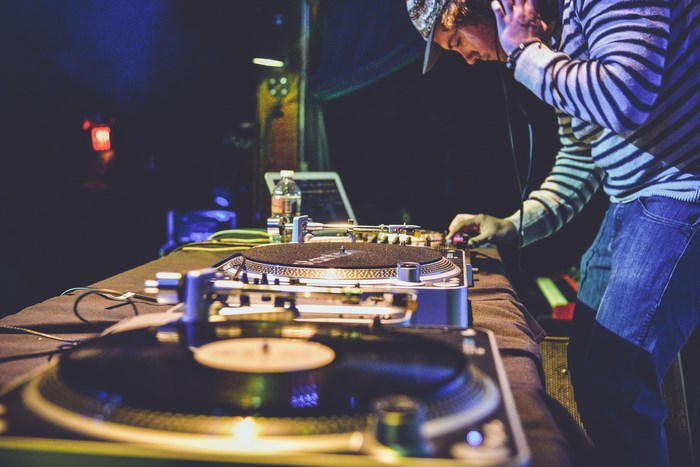 DJ mixing music on turntables at a concert