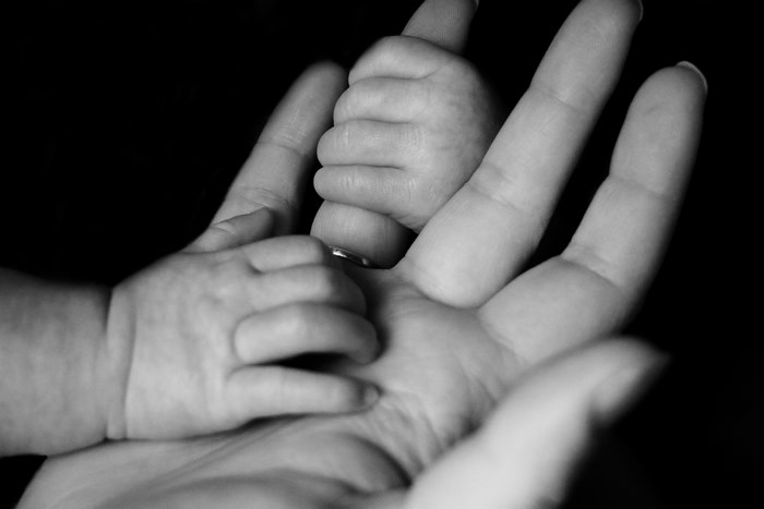 Black and White Image of Baby Holding Adult Hand