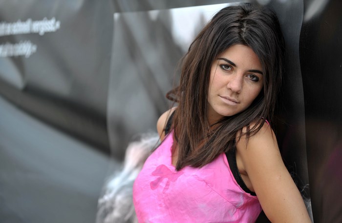 Marina Lambrini Diamandis leaning against a wall