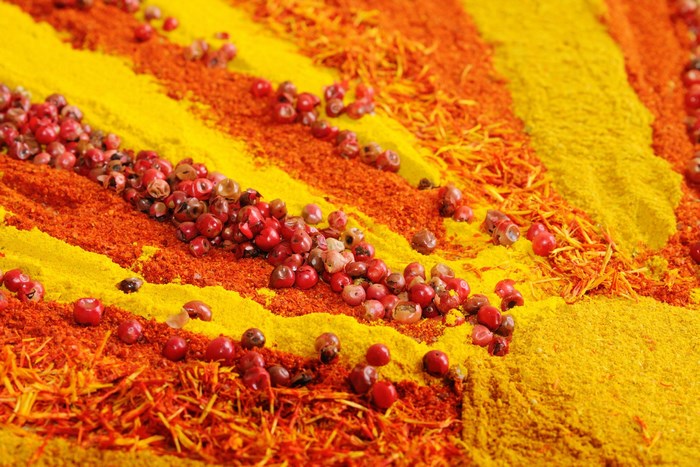 Colorful spices and peppercorns arranged in stripes