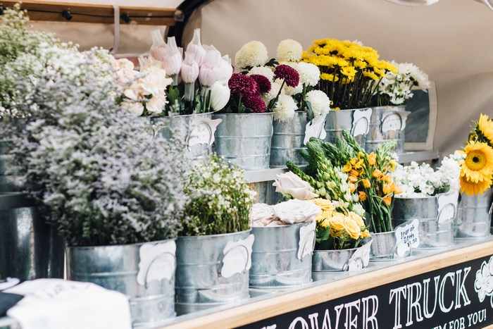 Flower truck with assorted flowers in metal buckets