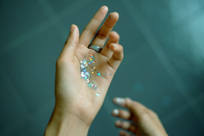 Hand holding colorful star glitter