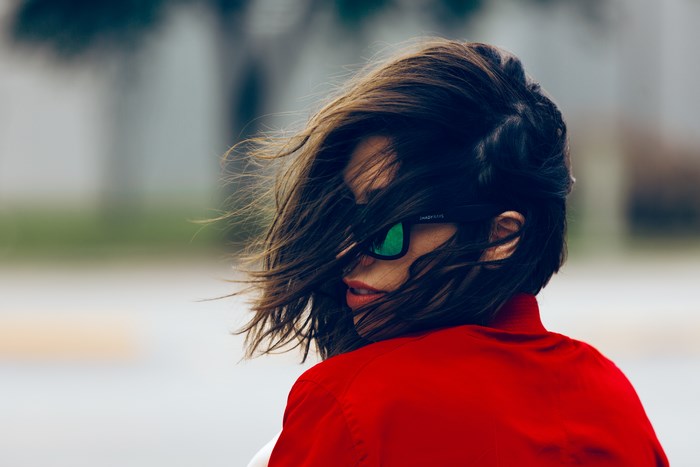 Woman with windblown hair and sunglasses