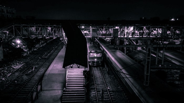 Nighttime View of Train Station Platform and Tracks