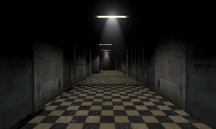 Dark prison hallway with checkered floor