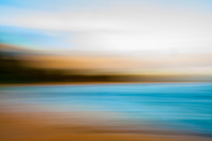 Abstract blur of ocean, beach, and sky