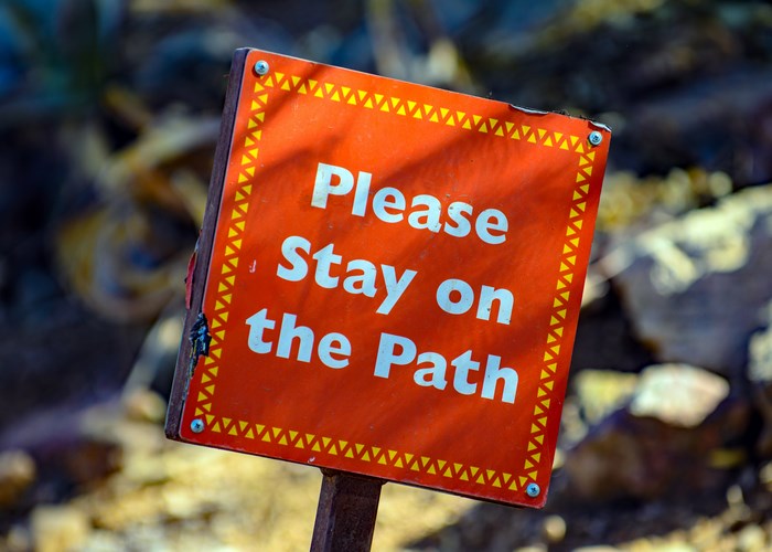 Orange sign: Please Stay on the Path
