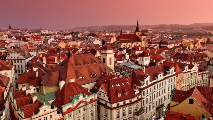 Prague cityscape with red rooftops at sunset