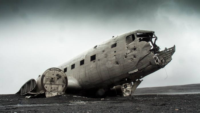 Crashed airplane wreckage on black sand beach in Iceland