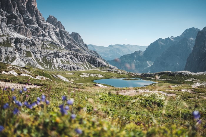 Serene Dolomite Mountain Valley with Pond and Wildflowers