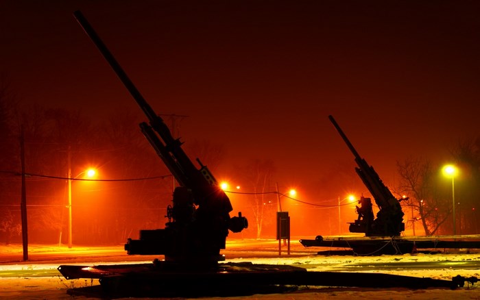 Artillery guns at night with streetlights