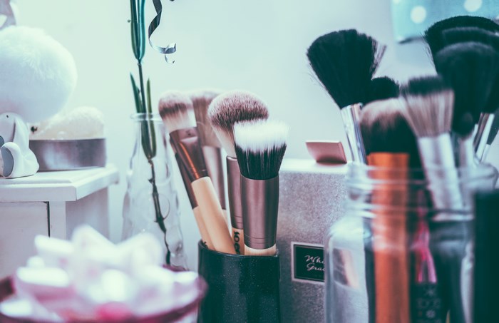 Makeup brushes in jars on a vanity