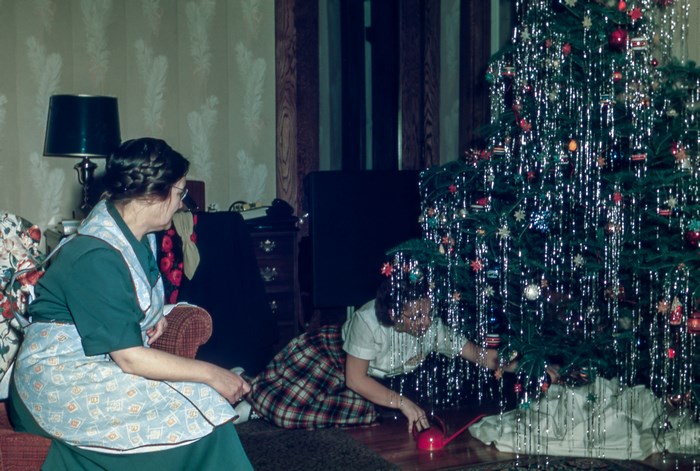 Woman and girl decorating a Christmas tree