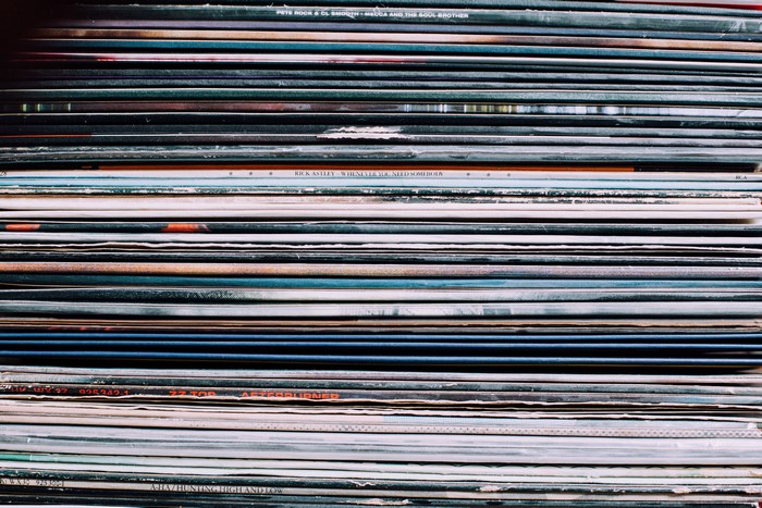 Stack of Vinyl Records with Visible Album Titles