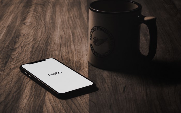 iPhone X and Red Wing Stoneware Mug on Wooden Table