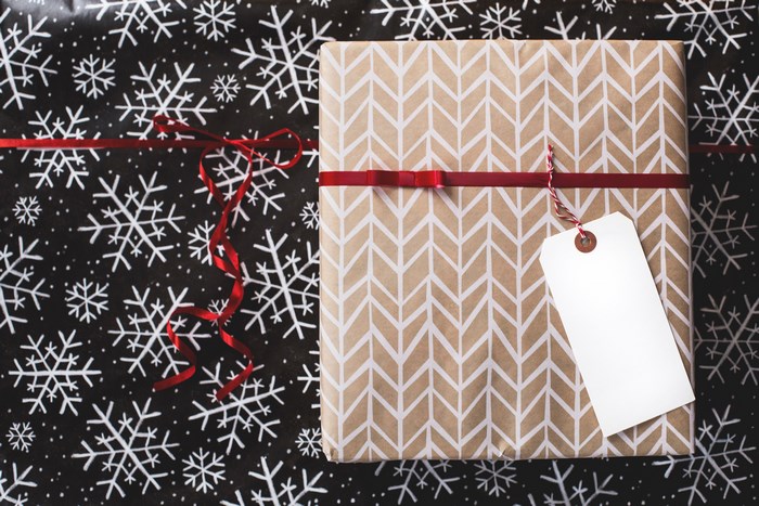 Christmas gift with snowflake wrapping paper and red ribbon